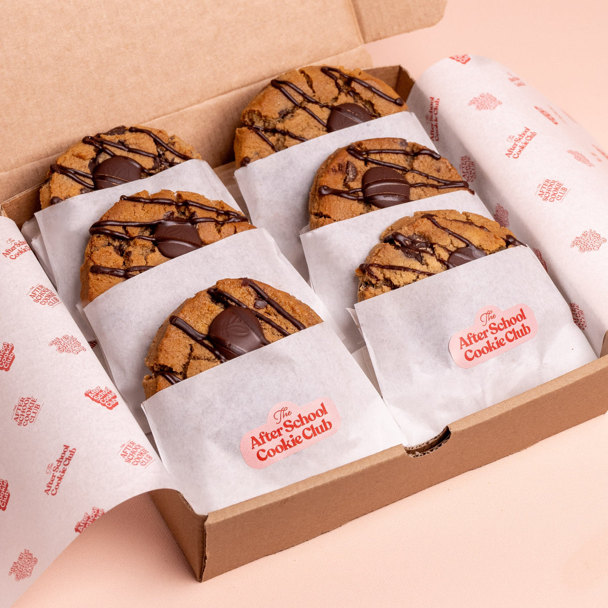 Box of cookies from The After School Cookie Club on a light pink background