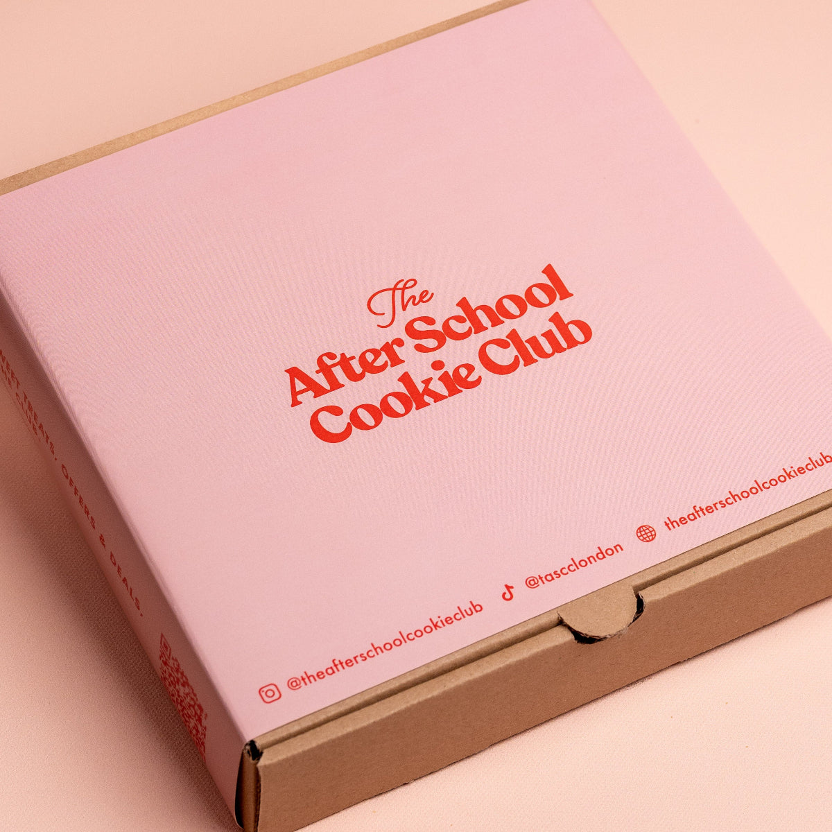 Pink box with 'The After School Cookie Club' text on a light pink background
