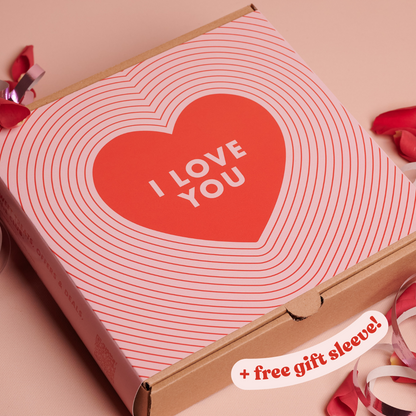 Cardboard box with a heart-shaped design and 'I Love You' text on a pink background.