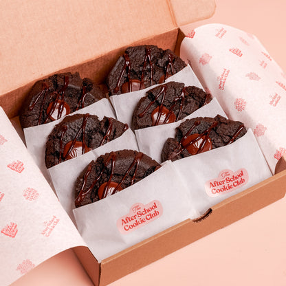 Box of double chocolate cookies on a pink background