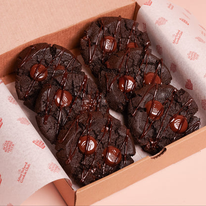 Box of double chocolate cookies on a pink background