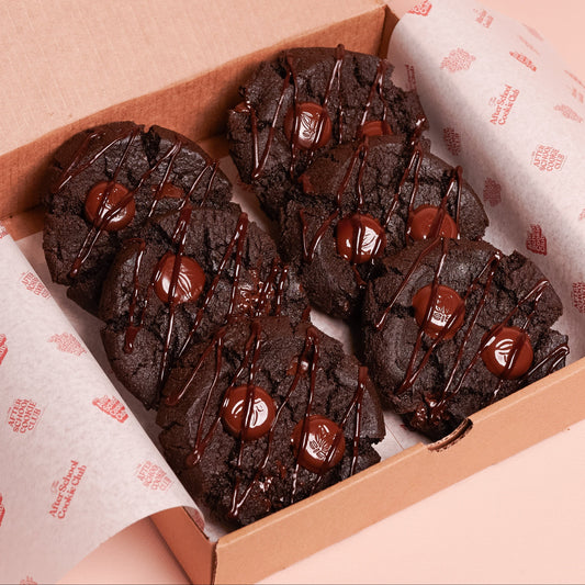 Box of double chocolate cookies on a pink background