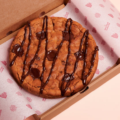 Giant Chocolate chip Cookie in a box on pink background