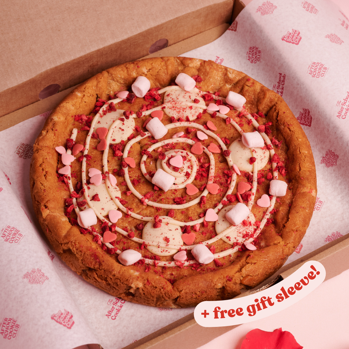 Giant White Chocolate Cookie with marshmallows and heart sprinkles on pink background